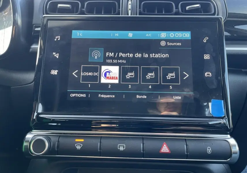 Écran tactile central de la Citroën C3 2024 avec commandes climatisation et alertes, finition noir brillant.