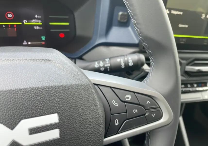 Gros plan sur le volant multifonction du Dacia Bigster 2025 avec commandes vocales et téléphone intégrées.