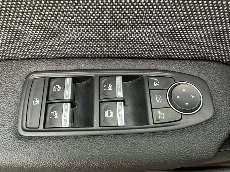 Panneau de commande des vitres électriques et rétroviseurs sur porte intérieure d’un Renault Captur 2025 Rouge Flamme/Noir Etoilé.