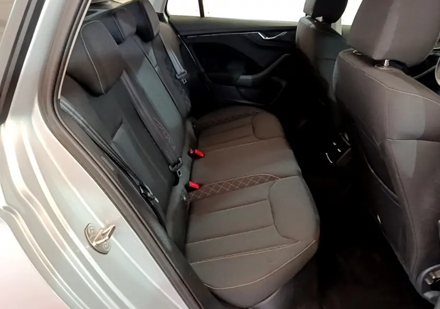 Vue intérieure arrière côté gauche du Skoda Kamiq gris clair 2022, sièges tissu noir avec surpiqûres contrastées.