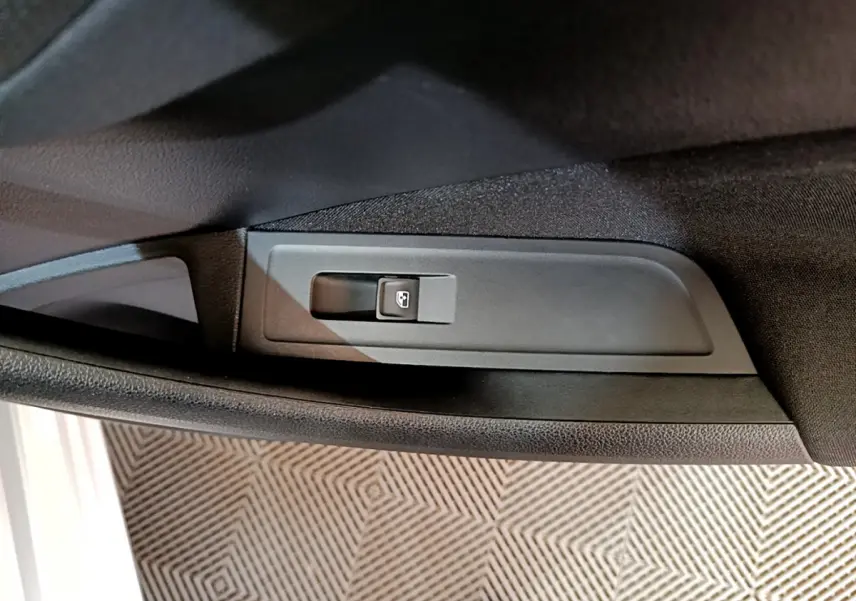 Bouton de commande de lève-vitre sur la portière côté conducteur d’un Skoda Kamiq gris clair 2022.