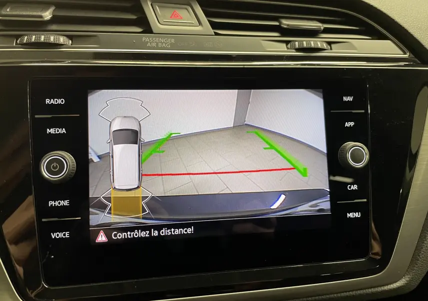 Affichage de la caméra de recul du Volkswagen Touran gris Dauphin 2024 avec guidage de trajectoire sur l'écran central.