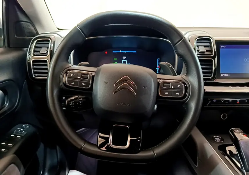 Intérieur du Citroën C5 Aircross Hybrid 225, vue centrée sur le volant cuir multifonctions et tableau de bord numérique.
