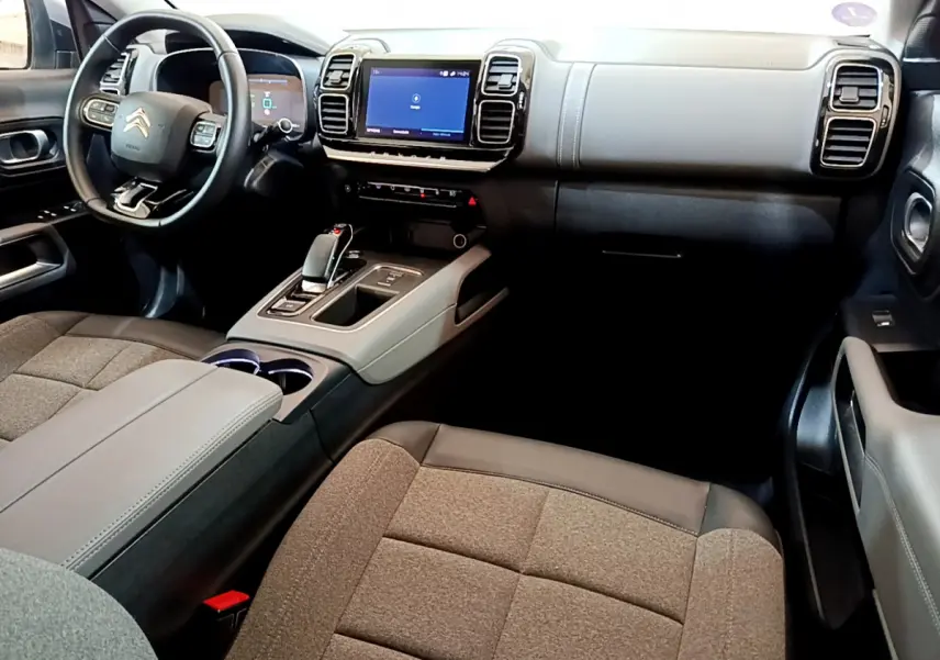 Intérieur du Citroën C5 Aircross Hybrid 225 Business, vue côté passager, tableau de bord gris clair avec écran tactile central.