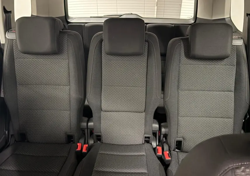 Vue intérieure centrée sur les trois sièges arrière noirs du Volkswagen Touran 2024, finition Life Plus.
