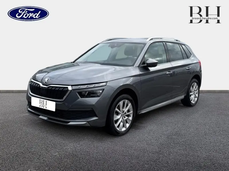 SKODA KAMIQ gris graphite métallisé en 3/4 avant droit, avec calandre chromée et jantes alu visibles.