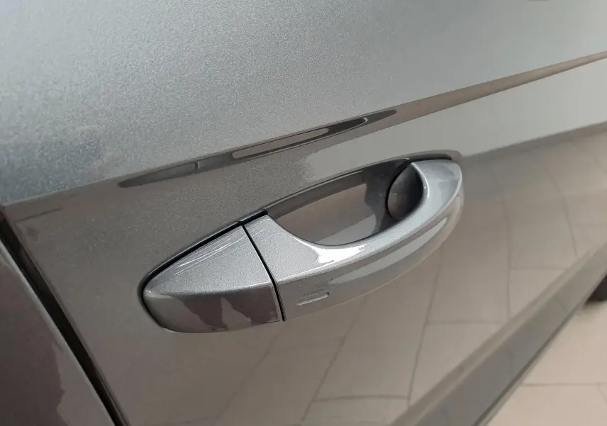 Poignée de porte côté gauche en gros plan sur Volkswagen T-Roc 2024 gris Indium métallisé.
