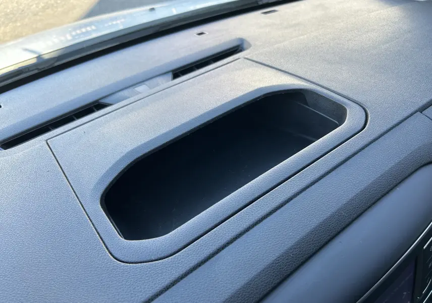 Détail du rangement intégré sur le tableau de bord gris foncé du Citroën Jumpy blanc, vue intérieure rapprochée.