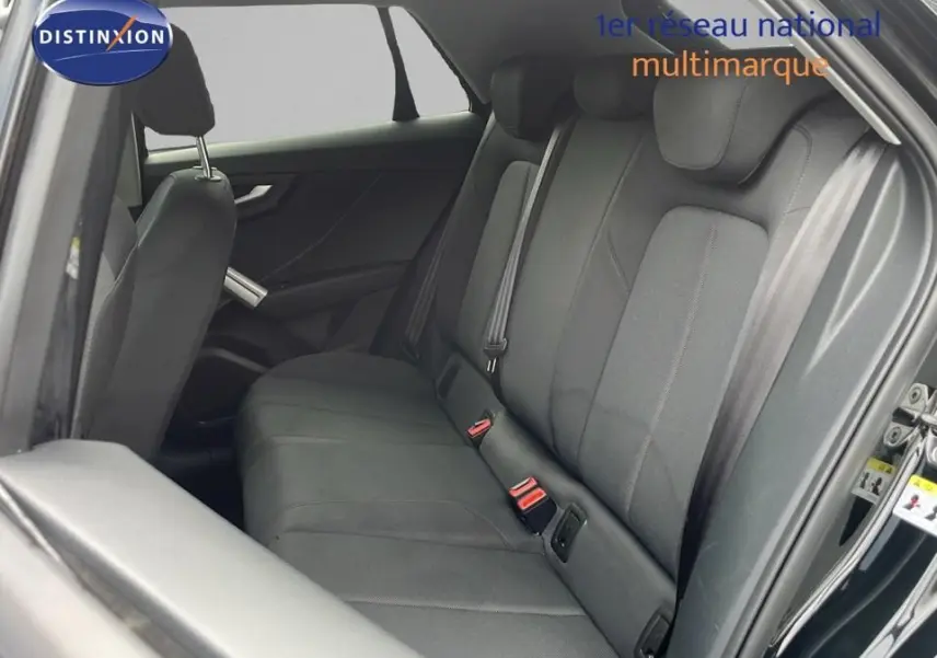 Vue intérieure côté droit des sièges arrière noirs en tissu de l'Audi Q2 35 TFSI S-Line 2023, porte ouverte.