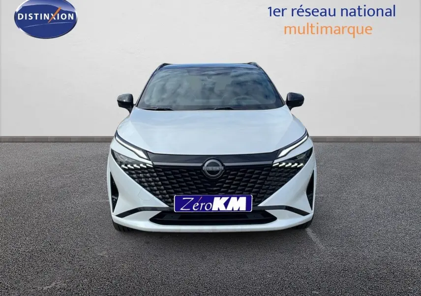 Vue frontale d'un Nissan Qashqai blanc nacré avec toit noir, calandre noire et phares LED modernes.