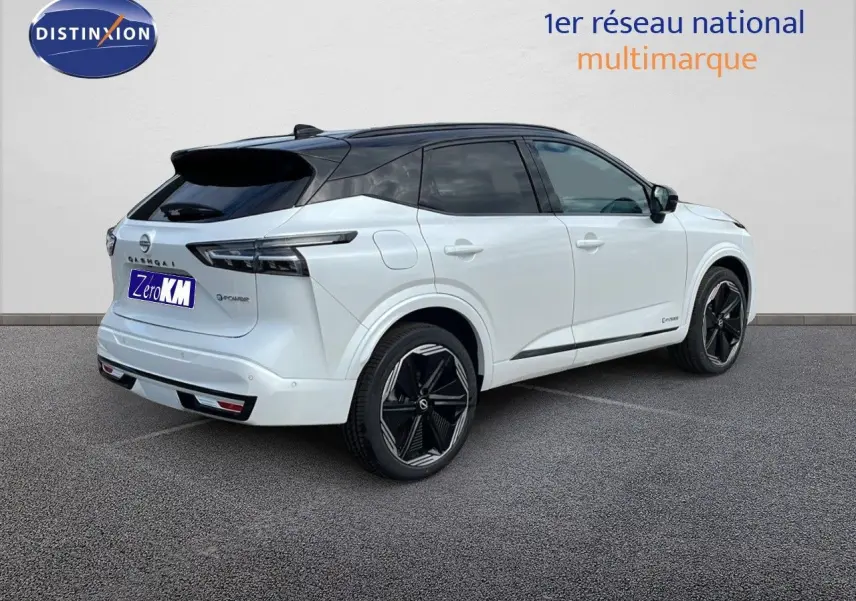 Nissan Qashqai 2025 blanc nacré métal avec toit noir, vue 3/4 arrière côté droit, jantes noires distinctives.