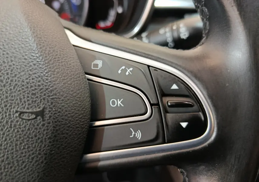 Gros plan sur les commandes multifonctions noires du volant cuir du Renault Kadjar Intens 2017.