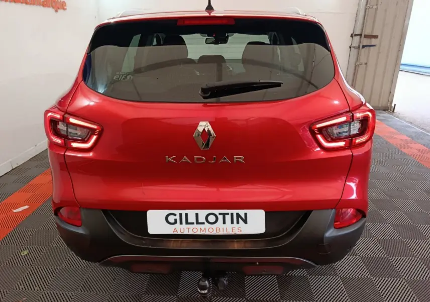 Vue arrière d'un Renault Kadjar rouge avec feux LED et attelage visible dans un garage.