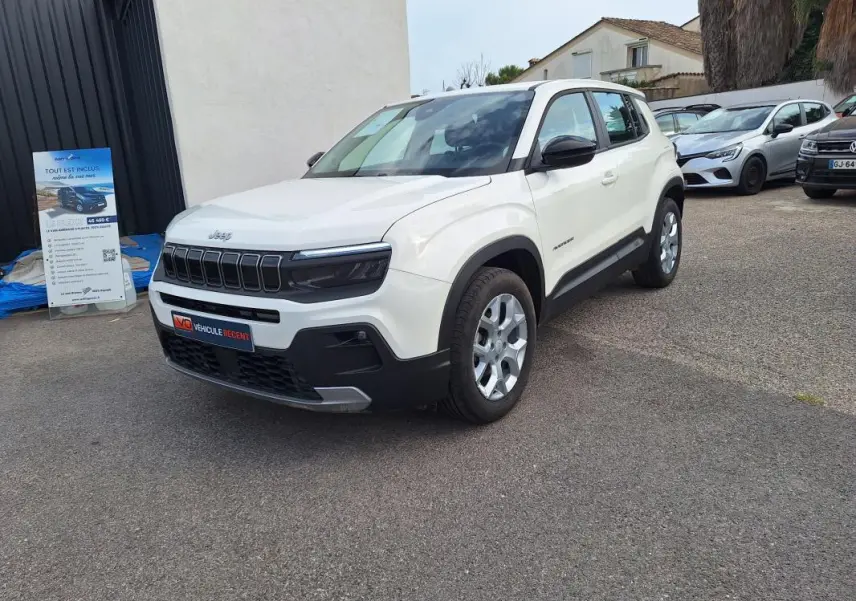 Jeep Avenger blanc en vue 3/4 avant droit, avec calandre noire et jantes alliage 17 pouces visibles.