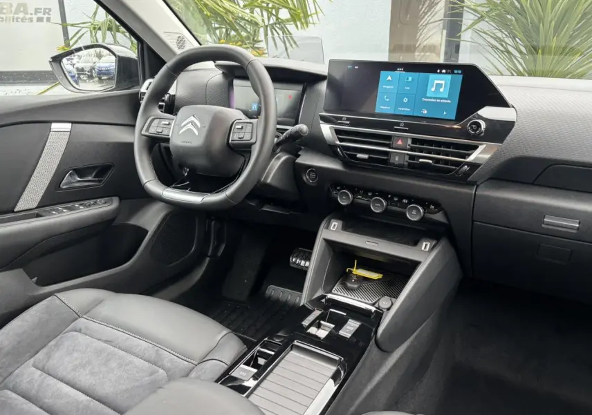 Intérieur avant droit de la Citroën C4 2024 avec volant cuir, écran tactile 10 pouces et sellerie Alcantara grise.