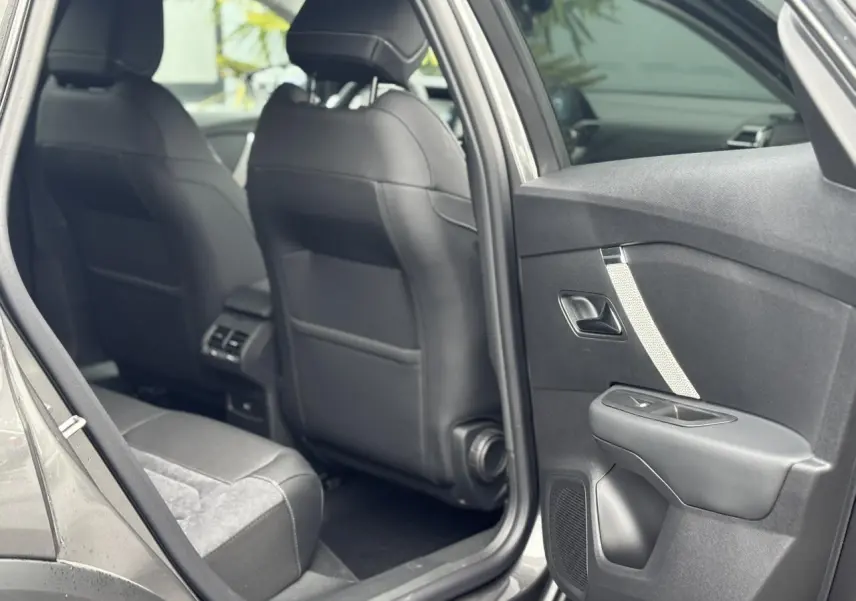 Vue intérieure côté arrière droit de la Citroën C4 2024 gris Platinium avec sièges en Alcantara et cuir noir.