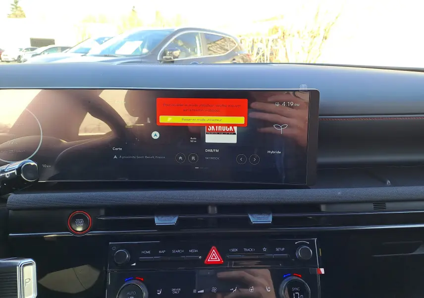 Vue intérieure du tableau de bord du Hyundai Tucson 2025 noir, avec écran tactile large et commandes climatisation visibles.