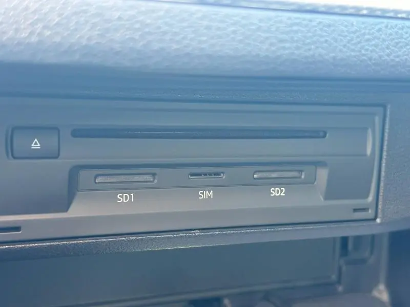 Gros plan sur le lecteur multimédia avec emplacements SD1, SIM et SD2 dans l'Audi Q2 35 TFSI 150ch S line 2023 noir Mythic.