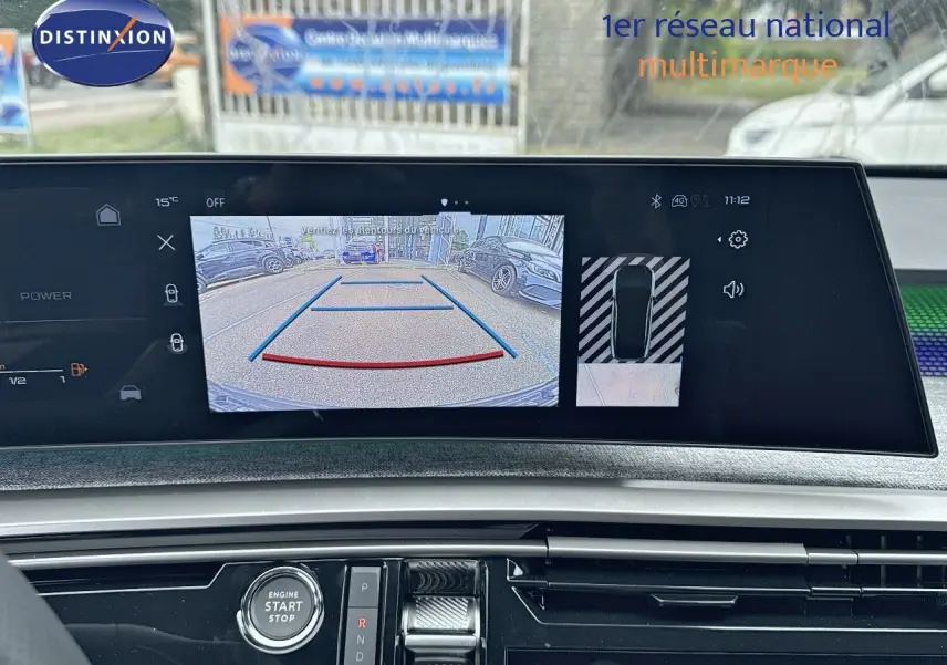 Vue du tableau de bord du Peugeot 3008 Hybrid 136ch GT 2025, écran affichant la caméra de recul avec aides au stationnement.