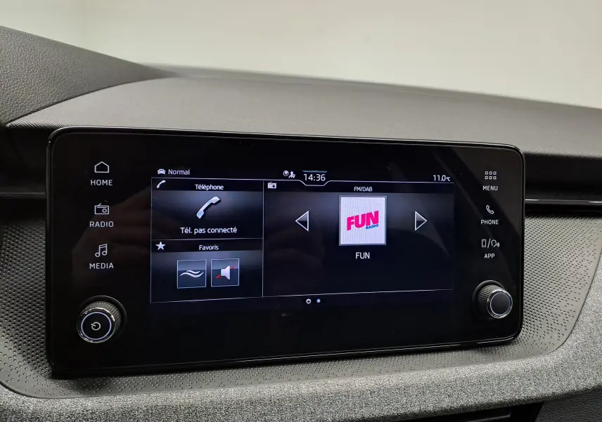 Écran tactile central du tableau de bord du Skoda Kamiq 2025, affichant la radio et les options multimédia.