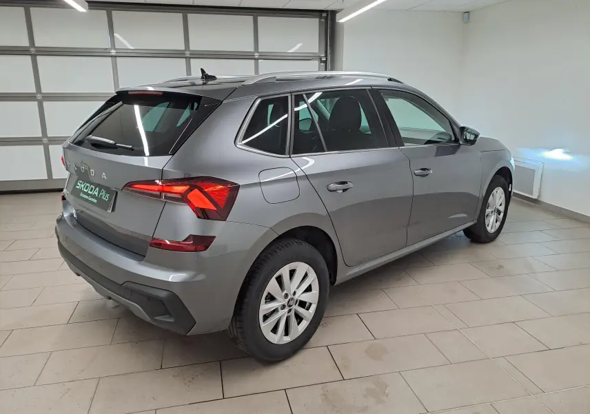 Vue 3/4 arrière droite d'un Skoda Kamiq gris graphite 2025 avec feux arrière LED et caméra de recul visible.