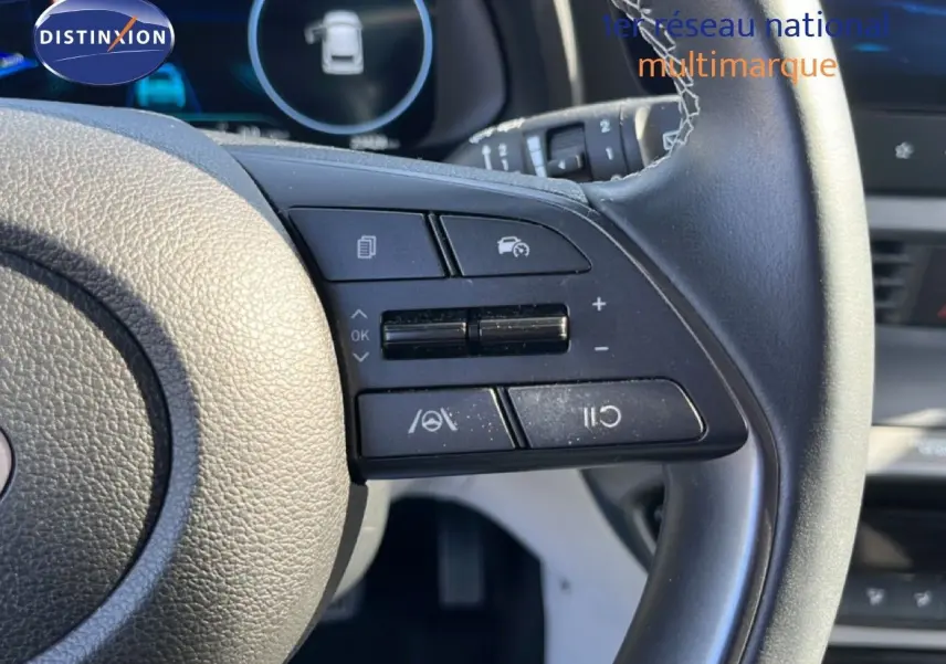 Gros plan sur le volant cuir noir de la Hyundai i20 2025, montrant les commandes de régulateur de vitesse et d'assistance.