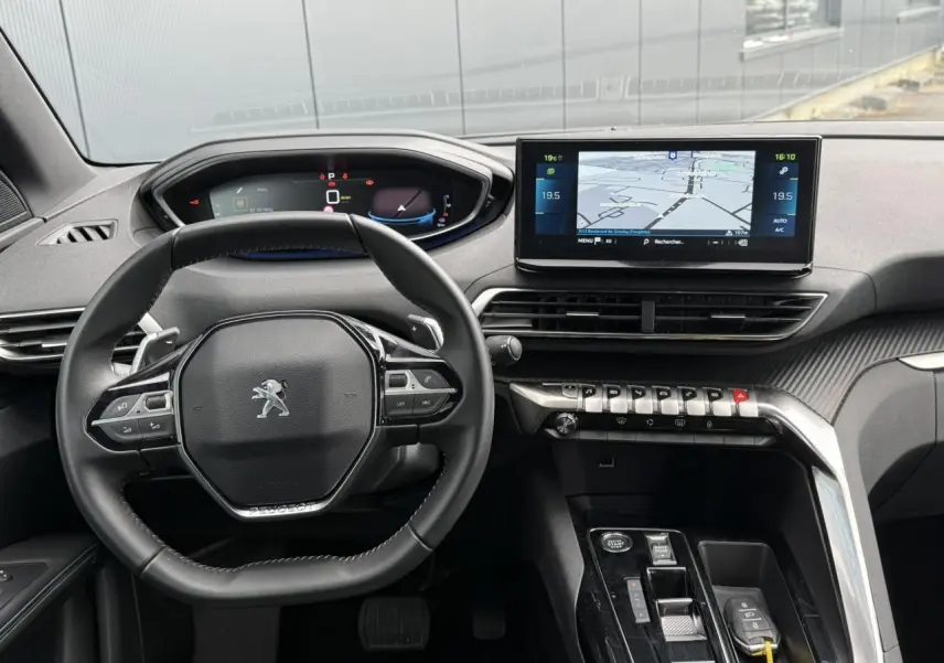 Vue intérieure frontale du tableau de bord du Peugeot 3008 Plug-in Hybrid 2024 avec volant compact et écran tactile de navigation.