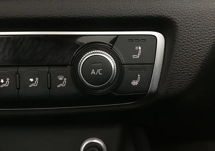 Gros plan sur les commandes de climatisation et sièges chauffants de l'Audi A3 Cabriolet noir 2020, finition S-Line.