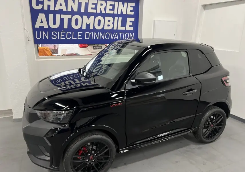 Vue 3/4 avant droite d'une LIGIER JS50 0.5 REVO D+ ULTIMATE noire avec jantes alu noires mates et badge Ultimate rouge.