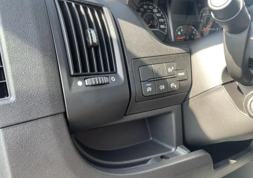 Détail du tableau de bord noir du Citroën Jumper 2023 avec commandes d'éclairage et ventilation côté gauche du conducteur.