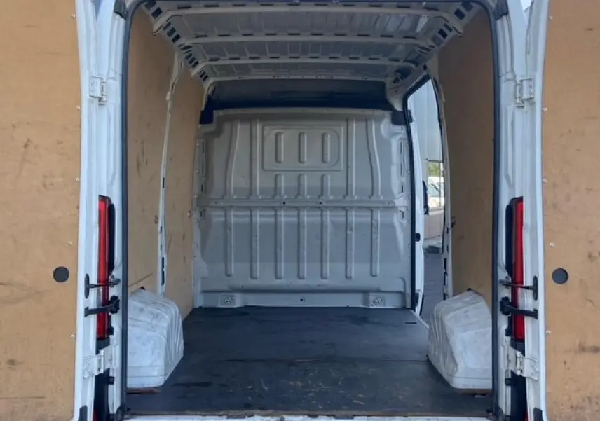 Vue arrière ouverte du Peugeot Boxer Fourgon blanc 2019, montrant l'intérieur utilitaire avec plancher bois et parois tôlées.