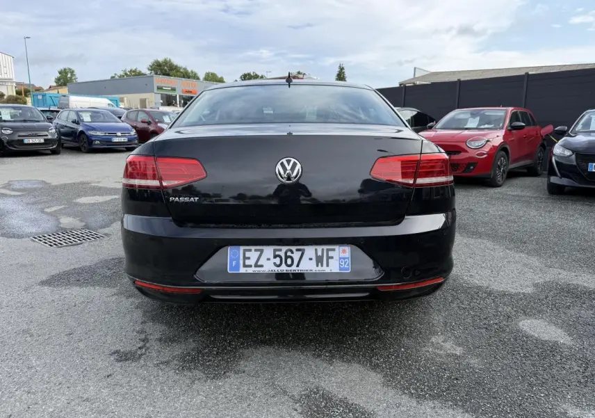 Vue arrière d'une Volkswagen Passat noire 2018 avec feux rouges et plaque d'immatriculation française visible.