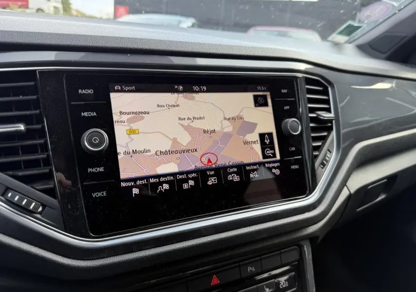 Écran central tactile du tableau de bord du Volkswagen T-Roc gris, affichant la navigation GPS en vue carte.