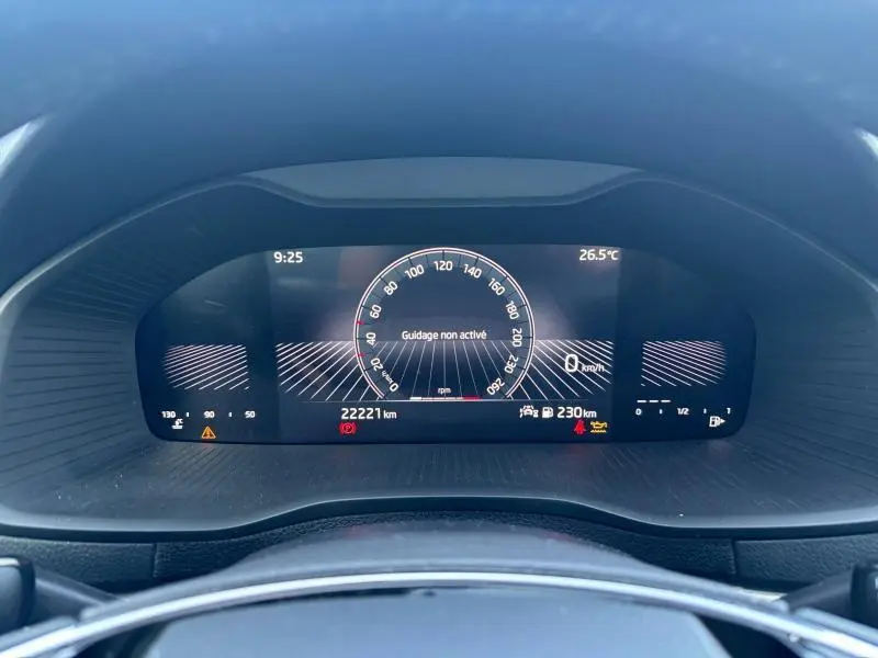 Tableau de bord numérique du Skoda Karoq blanc, affichant 22221 km et vitesse à 0 km/h, vue frontale rapprochée.