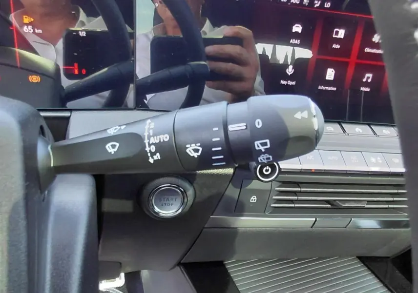 Gros plan sur la commande des essuie-glaces et le tableau de bord numérique de l’Opel Astra noire, version 2025.