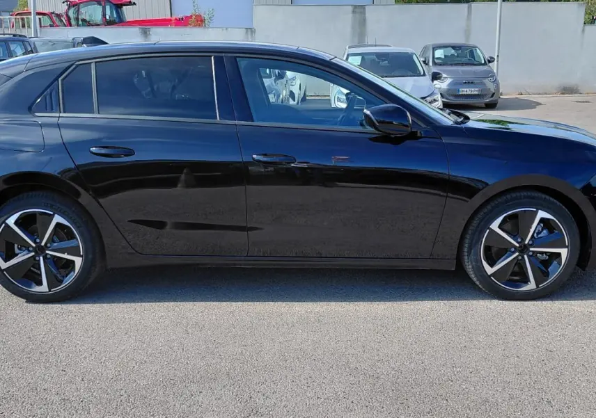 Opel Astra 2025 noire vue de profil côté gauche avec jantes alliage 17 pouces et vitres surteintées.