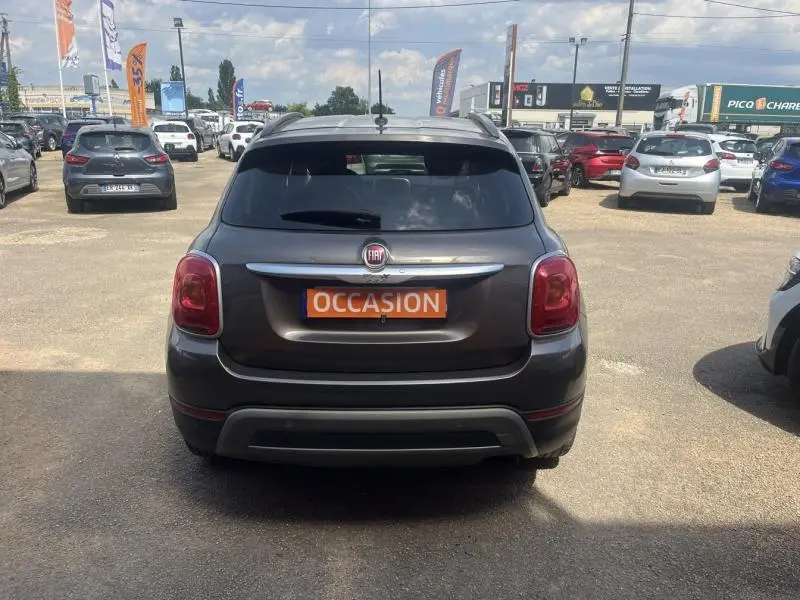 Vue arrière d'un FIAT 500X bronze métallisé avec plaque "OCCASION" sur un parking extérieur.