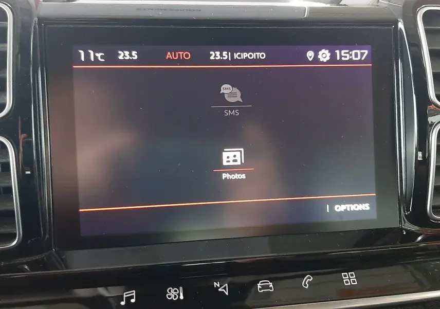 Écran tactile central du tableau de bord du Citroën C5 Aircross 2021 affichant le menu SMS et Photos, vue de face.