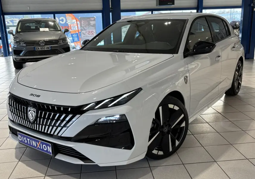 Peugeot 308 Hybrid blanc Okenite vue 3/4 avant droit avec calandre noire et jantes bi-tons en showroom.