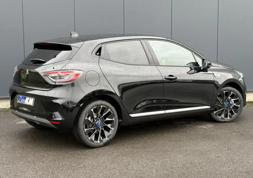 Vue 3/4 arrière côté droit d'une Renault Clio noire étoile avec jantes alliage et vitres surteintées.