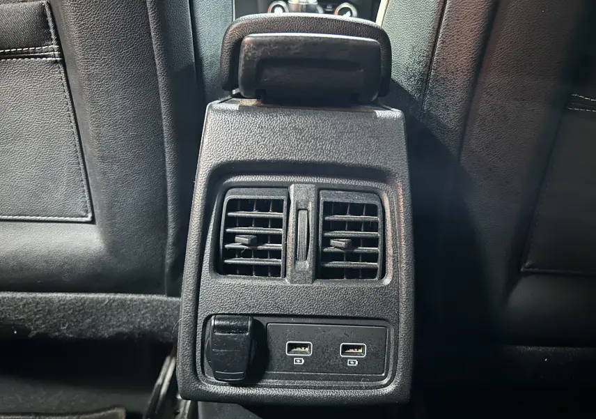 Vue rapprochée de la console arrière noire avec bouches d’aération et ports USB du Renault Captur gris 2020.