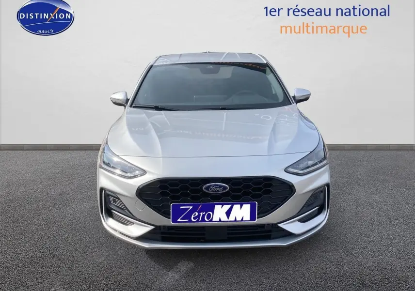 Vue frontale d'une Ford Focus gris clair avec calandre noire hexagonale et feux LED fins.