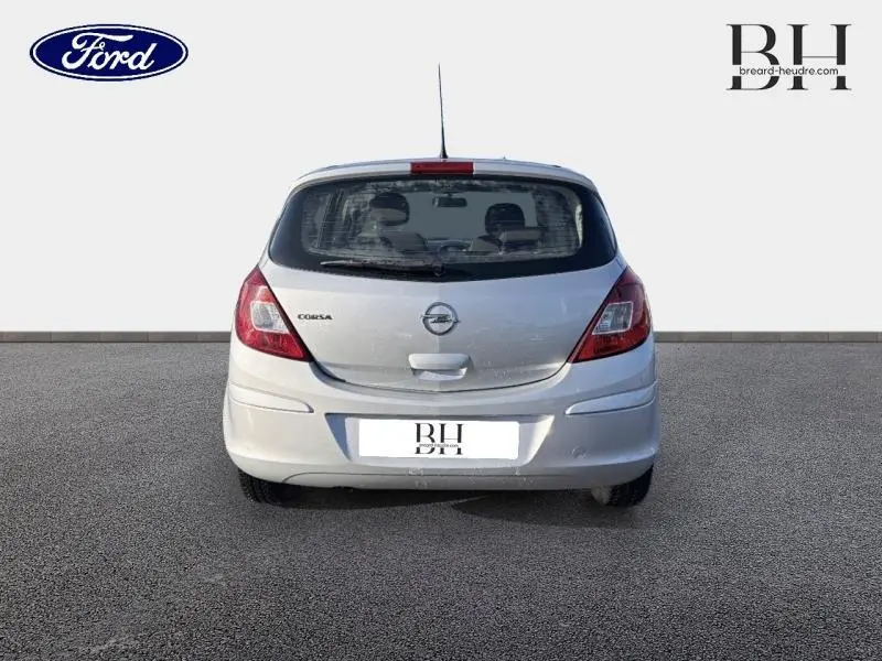 Vue arrière d'une Opel Corsa gris minéral 2014 avec feux arrière rouges et lunette arrière dégivrante visible.