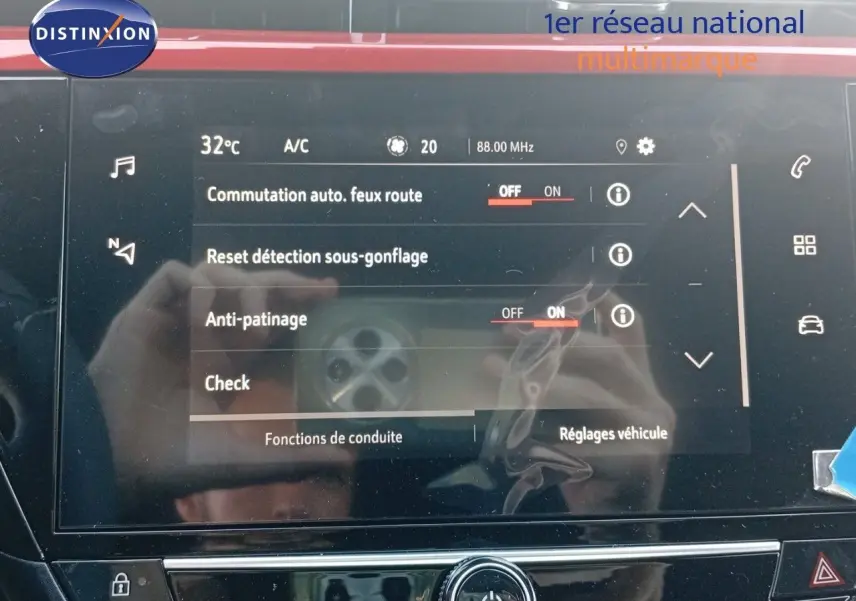 Écran tactile central de l’Opel Corsa rouge métal avec toit noir, affichant les réglages de conduite et sécurité.