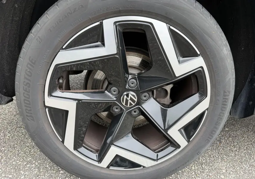 Gros plan sur la jante alliage 19 pouces Coventry bicolore noire et argentée du Volkswagen Tiguan gris 2025.