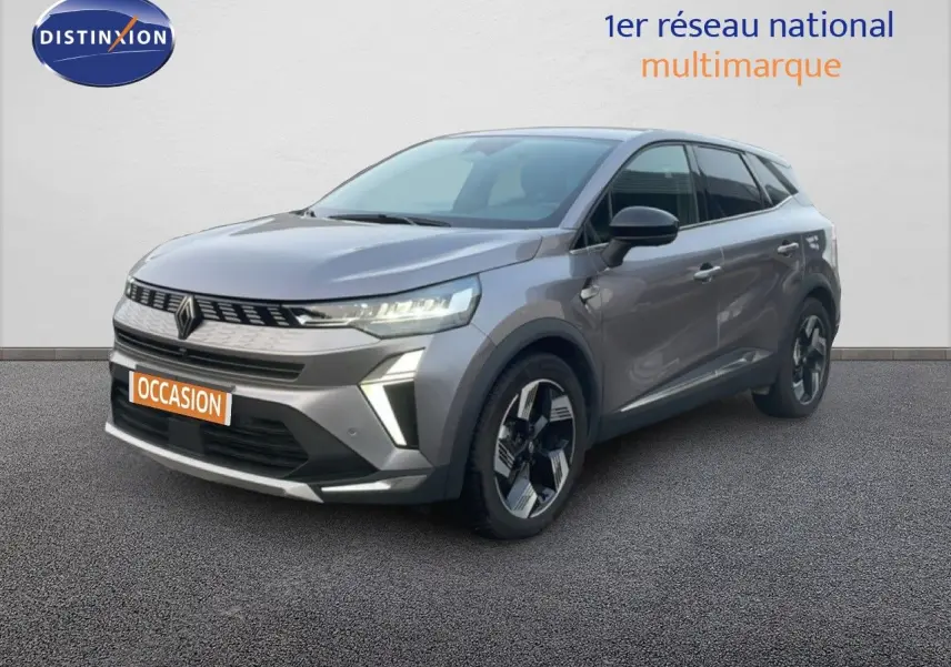 Renault Symbioz gris cassiopée métal en 3/4 avant droit, avec calandre moderne et jantes bicolores distinctives.