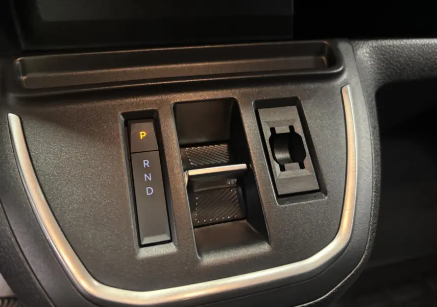 Gros plan sur la commande de boîte automatique noire avec indication P R N D du Fiat Scudo Fourgon gris foncé.