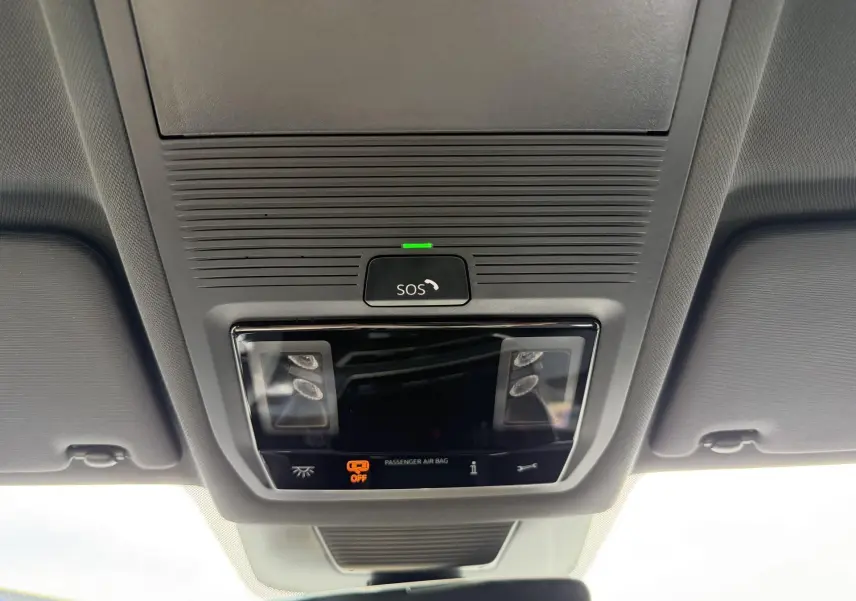 Vue en contre-plongée du plafonnier gris avec bouton SOS et éclairages intérieurs du Volkswagen Tiguan 2025.
