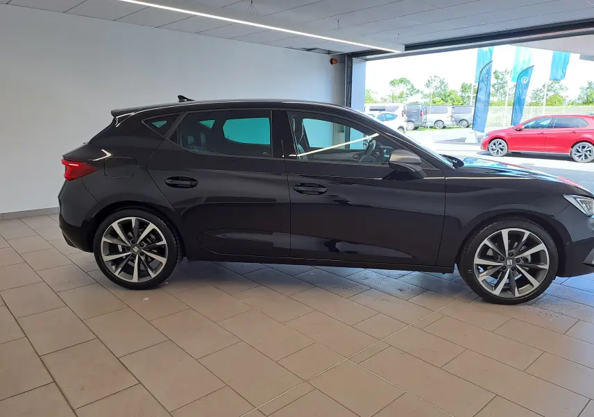 Profil côté gauche de la SEAT LEON 1.5 eTSI Hybrid 150 DSG7 FR 2024 en noir minuit, avec jantes alliage distinctives.