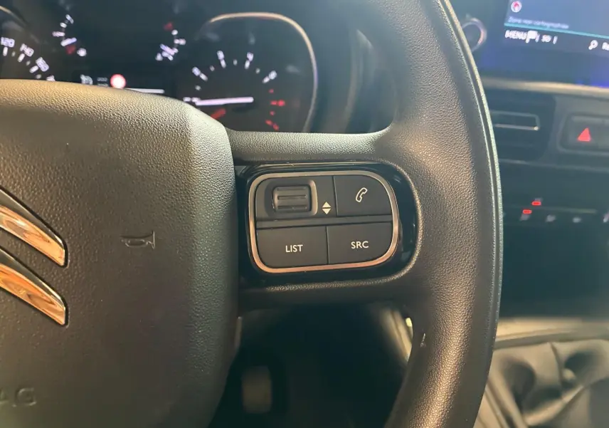 Gros plan sur le volant noir du Citroën Berlingo 2020, avec commandes audio et téléphone intégrées à droite.